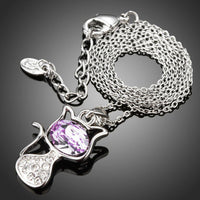 Side angle view of KHAISTA purple crystal cat pendant necklace