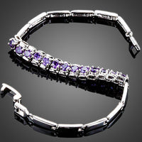 Close up detail of KHAISTA purple crystal charm cuff bracelet