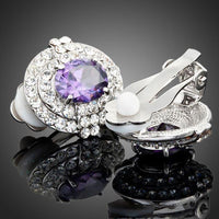 Close up of KHAISTA purple crystal dome stud earrings