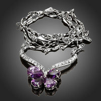 Side angle view of KHAISTA purple CZ butterfly pendant necklace
