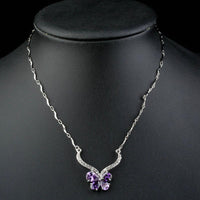 Close up detail of KHAISTA purple CZ butterfly pendant necklace