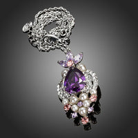 Side angle view of KHAISTA purple CZ imitation pearl necklace