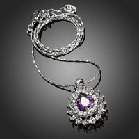 Side angle view of KHAISTA purple CZ pendant necklace
