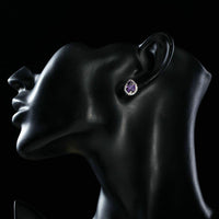 Side angle view of KHAISTA purple CZ pear shaped stud earrings