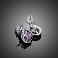 Close up of KHAISTA purple CZ pear shaped stud earrings