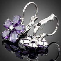 Close up of KHAISTA purple daisy crystal stud earrings