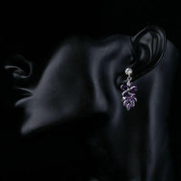 Close up of KHAISTA purple flower cluster drop earrings