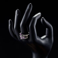 Side angle view of KHAISTA purple heart ring