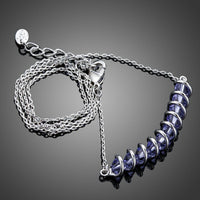 Close up detail of KHAISTA purple crystal link chain pendant necklace
