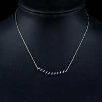 Side angle view of KHAISTA purple crystal link chain pendant necklace
