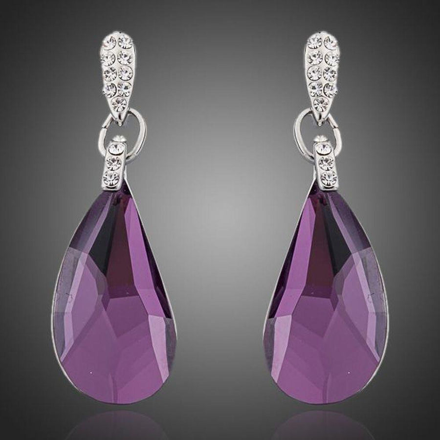 KHAISTA purple raindrop crystal drop earrings on white background