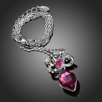 Side angle view of KHAISTA purple Stellux Austrian crystal necklace
