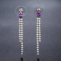 Close up of KHAISTA purple crystal tassel dangle earrings