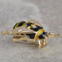 Close-up of crystal stones on gold honey bee brooch pin