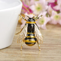 Khaista gold honey bee brooch pin on white background