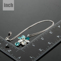 Close up detail of KHAISTA raindrop daisy crystal pendant necklace