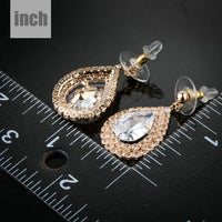 Close up of KHAISTA raindrop CZ drop earrings