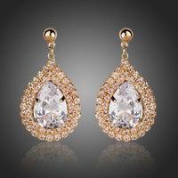 Side angle view of KHAISTA raindrop CZ drop earrings