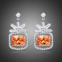 KHAISTA rectangle cut champagne drop earrings on white background