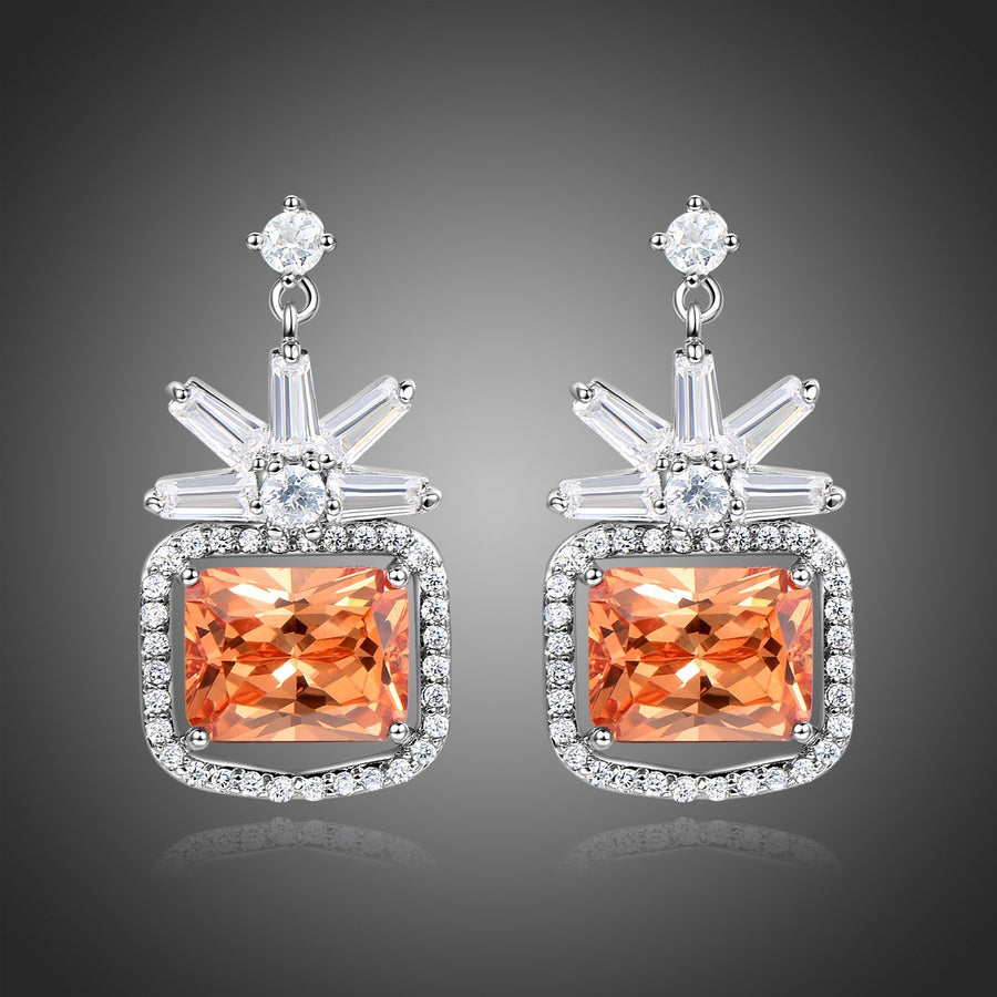 KHAISTA rectangle cut champagne drop earrings on white background