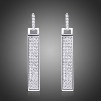 KHAISTA rectangle paved CZ dangle earrings on white background