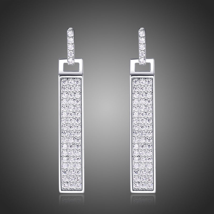 KHAISTA rectangle paved CZ dangle earrings on white background