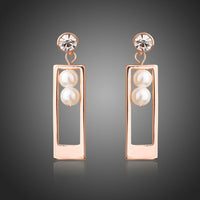 KHAISTA rose gold rectangle pearl drop earrings on white background