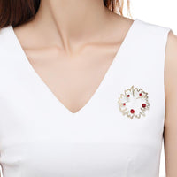 Close-up of red rhinestones on Khaista flower brooch