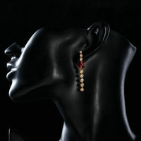 Side angle view of KHAISTA red crystal oval dangle drop earrings