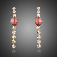 KHAISTA red crystal oval dangle drop earrings on white background