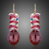 KHAISTA red crystal vine drop earrings on white background