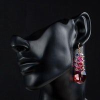 Side angle view of KHAISTA red crystal vine drop earrings