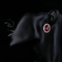 Close up of KHAISTA red CZ diamante oval stud earrings