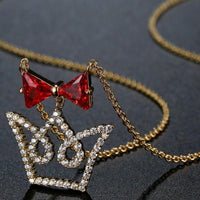 Close up detail of KHAISTA red CZ bow knot crown pendant necklace