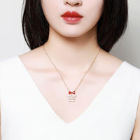 Pendant detail on KHAISTA red CZ bow knot crown pendant necklace