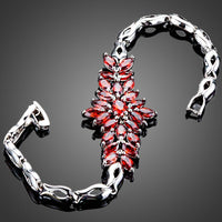 Close up detail of KHAISTA red cubic zirconia chain bracelet