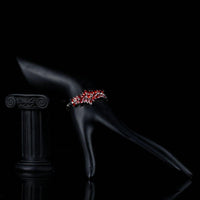 Side angle view of KHAISTA red cubic zirconia chain bracelet