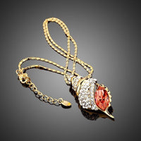 Close up detail of KHAISTA red paved crystal pendant necklace