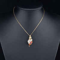 Side angle view of KHAISTA red paved crystal pendant necklace