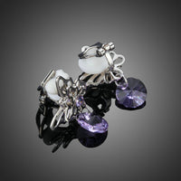Close up of KHAISTA rhinestone butterfly clip earrings