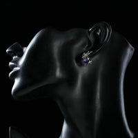 Side angle view of KHAISTA rhinestone butterfly clip earrings