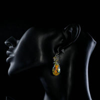 Side angle view of KHAISTA rhinestone crystal water drop earrings