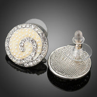 Side angle view of KHAISTA rhinestone flower stud earrings