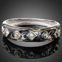 KHAISTA rhodium plated black artistic cuff bangle on white background