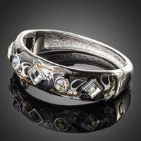 Close up detail of KHAISTA rhodium plated black artistic cuff bangle