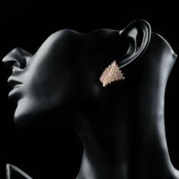 Side angle view of KHAISTA rhombic crystal stud earrings
