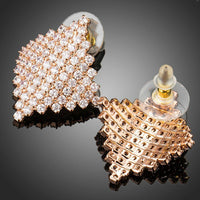 Close up of KHAISTA rhombic crystal stud earrings