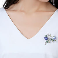 Close-up of oil paint detail on Khaista pomegranate brooch