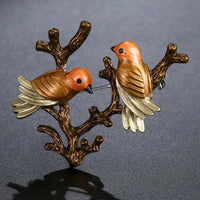 Side angle view of Khaista oil paint bird brooch