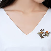 Close-up of oil paint detail on Khaista bird brooch